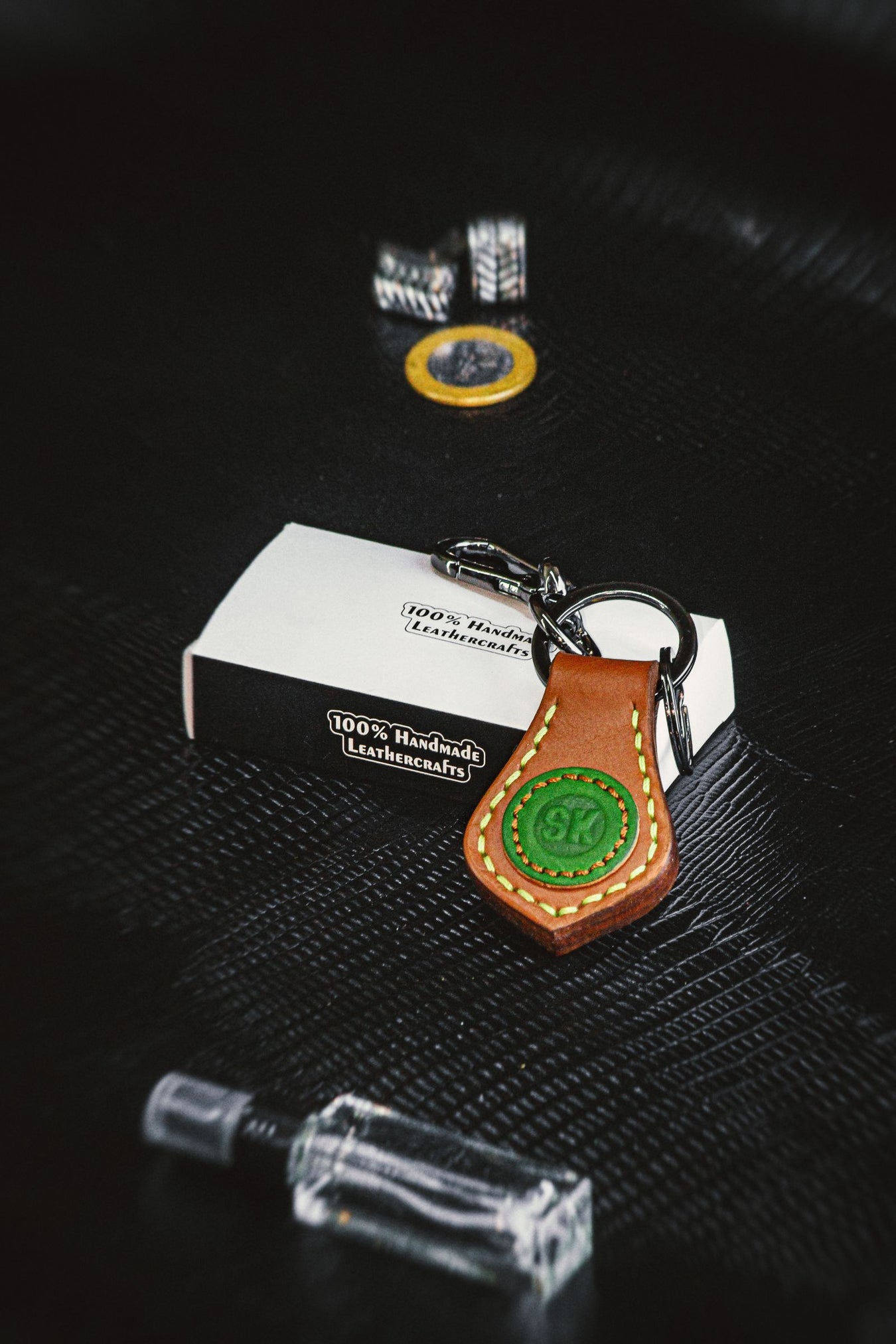 Handmade leather keychain on dark surface