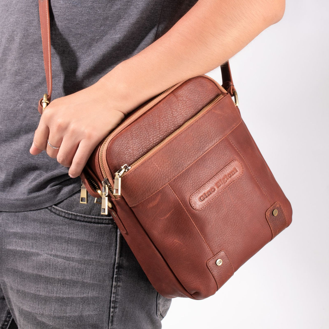 Man with leather crossbody bag urban style